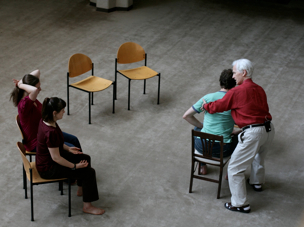 Alexander Technique teacher Alexander Murray giving chair turn to teacher-trainee.